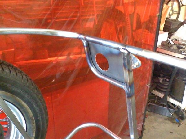 A little sub-frame and plate to support the fuel cap and weight of the gas station's pump nozzle.